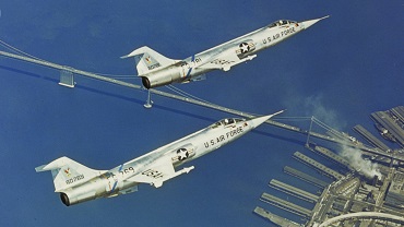 Armed with wingtip AIM-9B Sidewinder missiles, two F-104A Starfighters from the 83rd Fighter Interceptor Squadron tighten up their formation over the San Francisco Bay circa 1958. (Lockheed Martin)